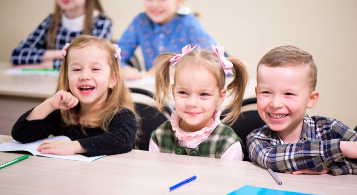 Primary school children work together in class